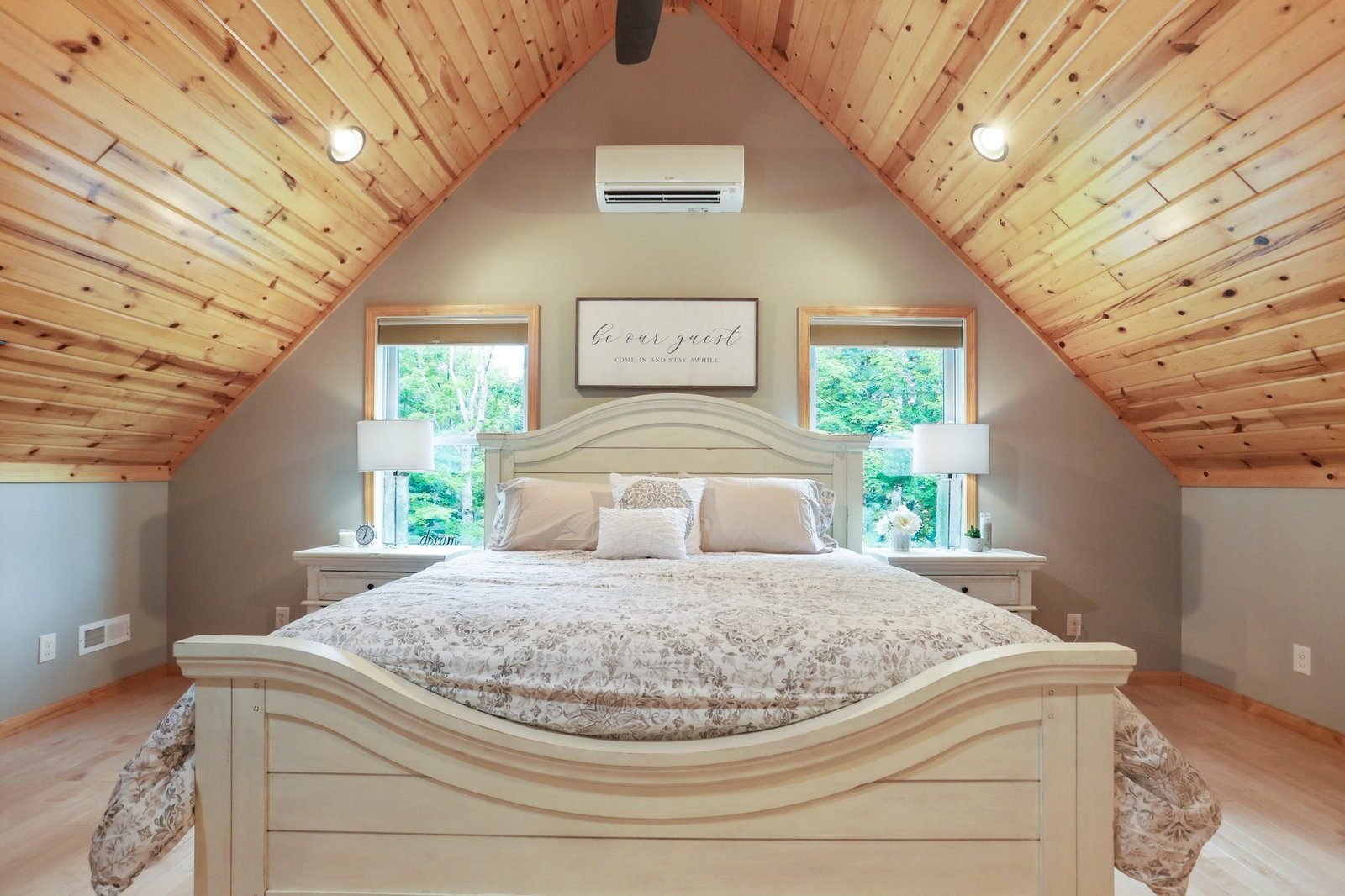 The second-floor king bedroom under its cedar-plank cathedral ceiling